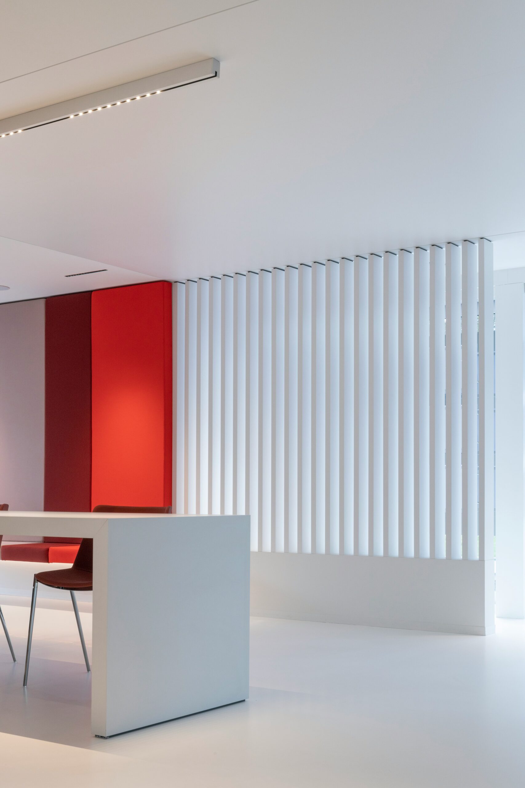 casa stile minimalista con parete rossa e pavimento in resina bianca